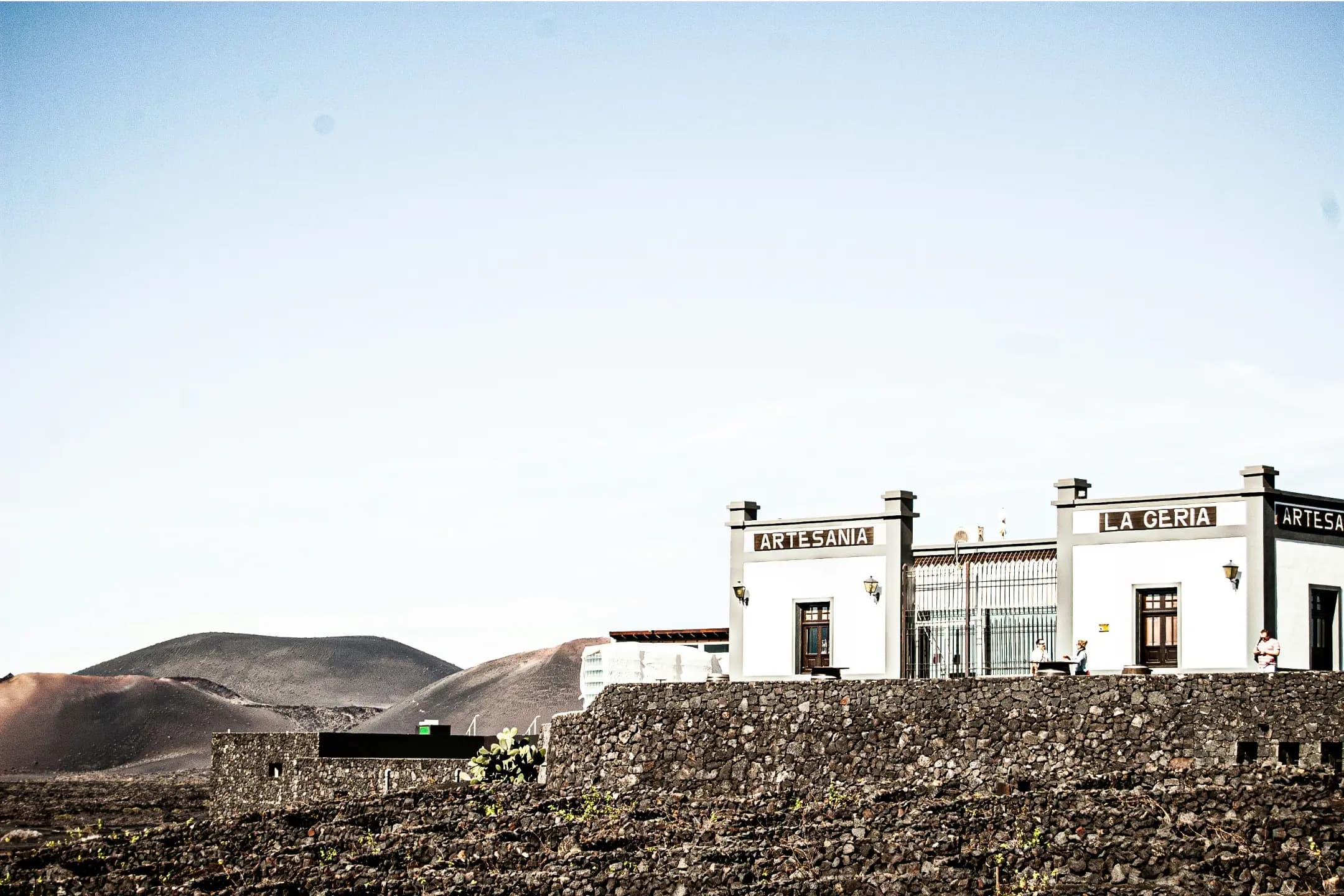 Historic El Grifo winery with traditional volcanic stone architecture and wine museum